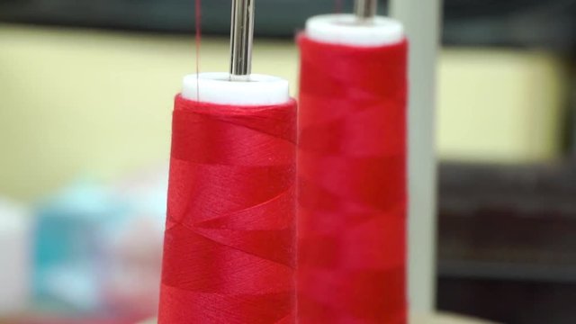 two bobbins with red thread, polyamide used for the manufacture of knitted clothing. Close up