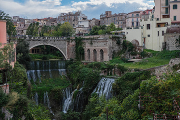 View of Tivoli from Gregorian villa with waterfalls and arch bridge