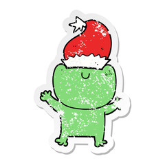 distressed sticker of a cute cartoon frog wearing christmas hat