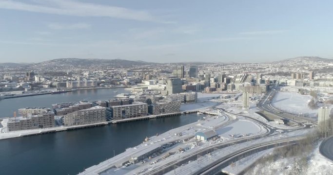 4K high angle aerial view of the beautiful Oslo skyline, The Munch Museum called Lambda and Barcode, a part of the new Bj&oslash;rvika Opera quarter, in vibrant winter sunlight.