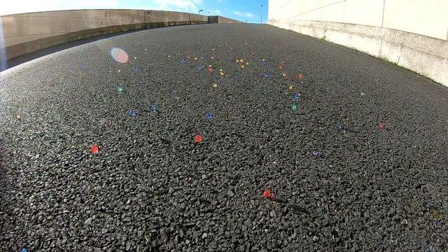 Colour Balls Bouncing On Driveway To Join  Together.