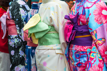 Japanese women wearing traditional Kimono walk on the streets of Kyoto, Japan.