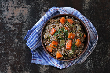 Buckwheat porridge with vegetables and herbs in a bowl. The concept of dietary nutrition. Buckwheat diet