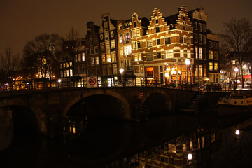 Fototapeta na wymiar famous bridge in amsterdam. romantic night landscape. a bit of haze and fog makes the magic channel