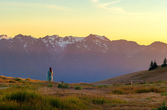 Visitors watching sunset over snow capped mountains of Hurricane ridge in Olympic national park, Washington, USA