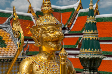 Golden Guardian Statue in the Temple of the Emerald Buddha Wat Phra Kaew in Bangkok Thailand.