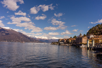 Italy, Bellagio, Lake Como, Varenna, BUILDINGS AT WATERFRONT AGAINST CLOUDY SKY