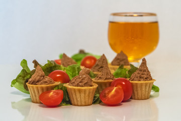 tartlets with liver pate decorated with lettuce and cherry tomatoes