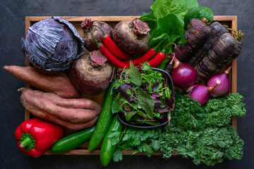 Organic vegetables in wooden tray. Top view