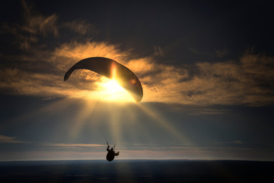 Paraglider during the flight in the sunlight