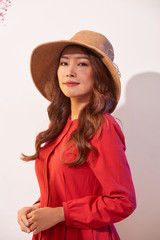 Woman wearing a straw hat and smiling.
