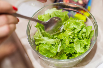 Cooking salad from fresh herbs.