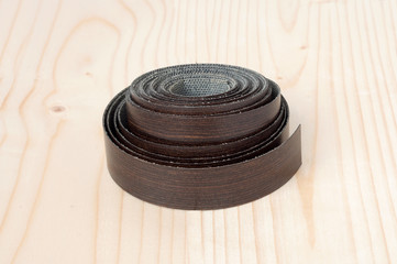 the edges of melamine chipboard on wooden background