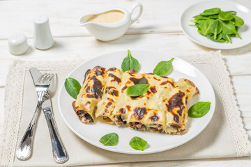 Cannelloni with minced beef and spinach baked in béchamel sauce. 