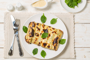 Cannelloni with minced beef and spinach baked in béchamel sauce. The view from the top. Copy-space.   
