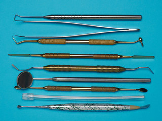 Professional dental tools on blue background. Dental health concept