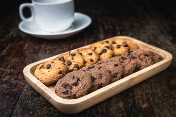 Chocolate chip cookies Closeup with cup on wooden tabel.