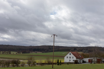 Fototapeta na wymiar Green fields and blue skies over hessen in Germany