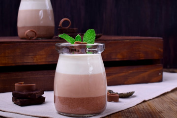 Three chocolate mousse dessert in a glass jar