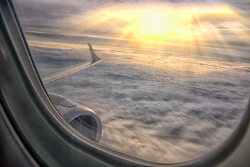 Clouds and sky as seen through window of an aircraft