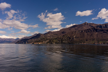 Italy, Bellagio, Lake Como, a body of water with a mountain in the background