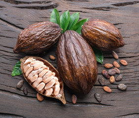 Cocoa pod and cocoa beans on the wooden table. Top view.