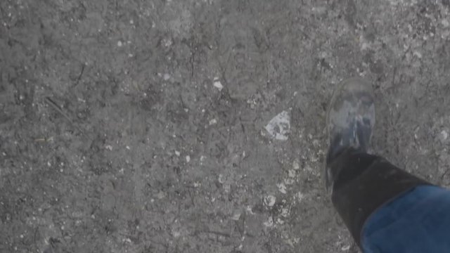 Muddy boots running down muddy path in slow motion