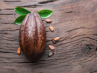 Cocoa pod and cocoa beans on the wooden table. Top view.