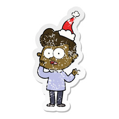 distressed sticker cartoon of a staring man wearing santa hat