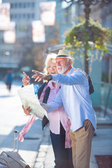 Obraz na płótnie Canvas Senior couple of tourists looking at city map