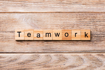TEAMWORK word written on wood block. TEAMWORK text on wooden table for your desing, concept