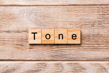 tone word written on wood block. tone text on wooden table for your desing, concept