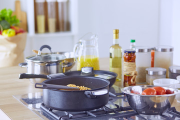 Composition with wooden board and ingredients for cooking on table