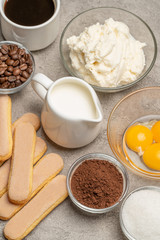 Ingredients for cooking tiramisu Savoiardi biscuit cookies, mascarpone, cream, sugar, cocoa, coffee and egg