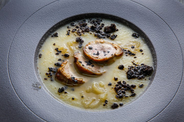 closeup delicious cream soup decorated with homemade sausage