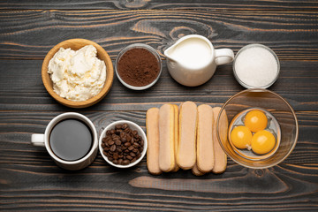 Ingredients for cooking tiramisu Savoiardi biscuit cookies, mascarpone, cream, sugar, cocoa, coffee and egg