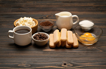 Ingredients for cooking tiramisu Savoiardi biscuit cookies, mascarpone, cream, sugar, cocoa, coffee and egg