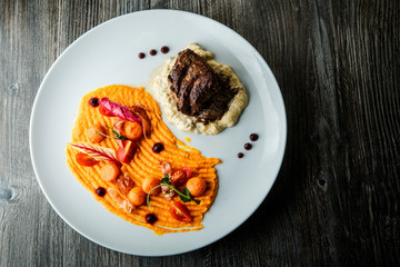 top view big tasty piece of well done grilled meat steak on potato puree