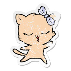 Obraz na płótnie Canvas distressed sticker of a cartoon dancing cat with bow on head