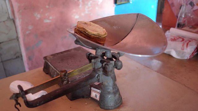 A 1 kilo stack of freshly made tortillas sitting on a scale after being weighed.