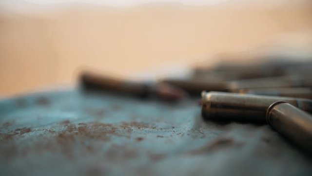 Man picking up bullet for M16.