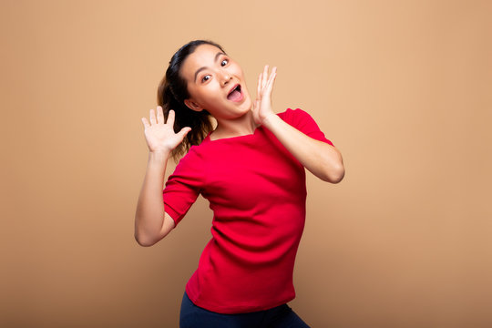Portrait of excited woman isolated over background
