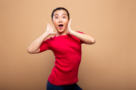 Portrait of excited woman isolated over background