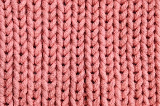 Pink merino yarn knitted texture for background. Living coral color trend of the year 2019