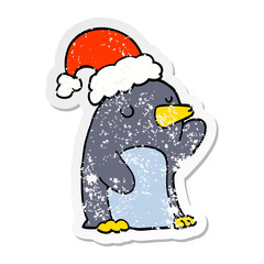 distressed sticker of a cute cartoon christmas penguin