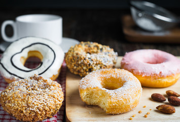 Donut and coffee cup set on wooden table.