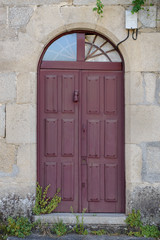 Fototapeta na wymiar antique wooden door in a stone wall