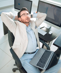 thoughtful businessman sitting in front of the Desk