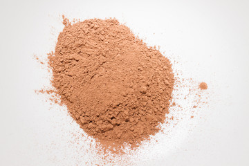 Dry cocoa powder poured in a mixing bowl