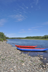  Two inflatable canoes on the shore of  North river.